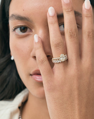 Model wears Cler 0.20ct oval half eternity band in 18ct yellow gold