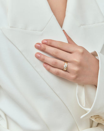Model wear Cornelia round brilliant pear side stone engagement ring with diamond band in 18ct yellow gold