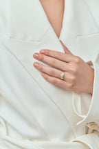 Model wear Cornelia round brilliant pear side stone engagement ring with diamond band in 18ct yellow gold
