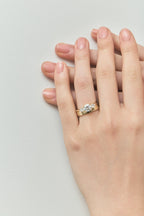 Close-up Cornelia round brilliant pear side stone engagement ring with lab-grown diamond band in 18ct yellow gold