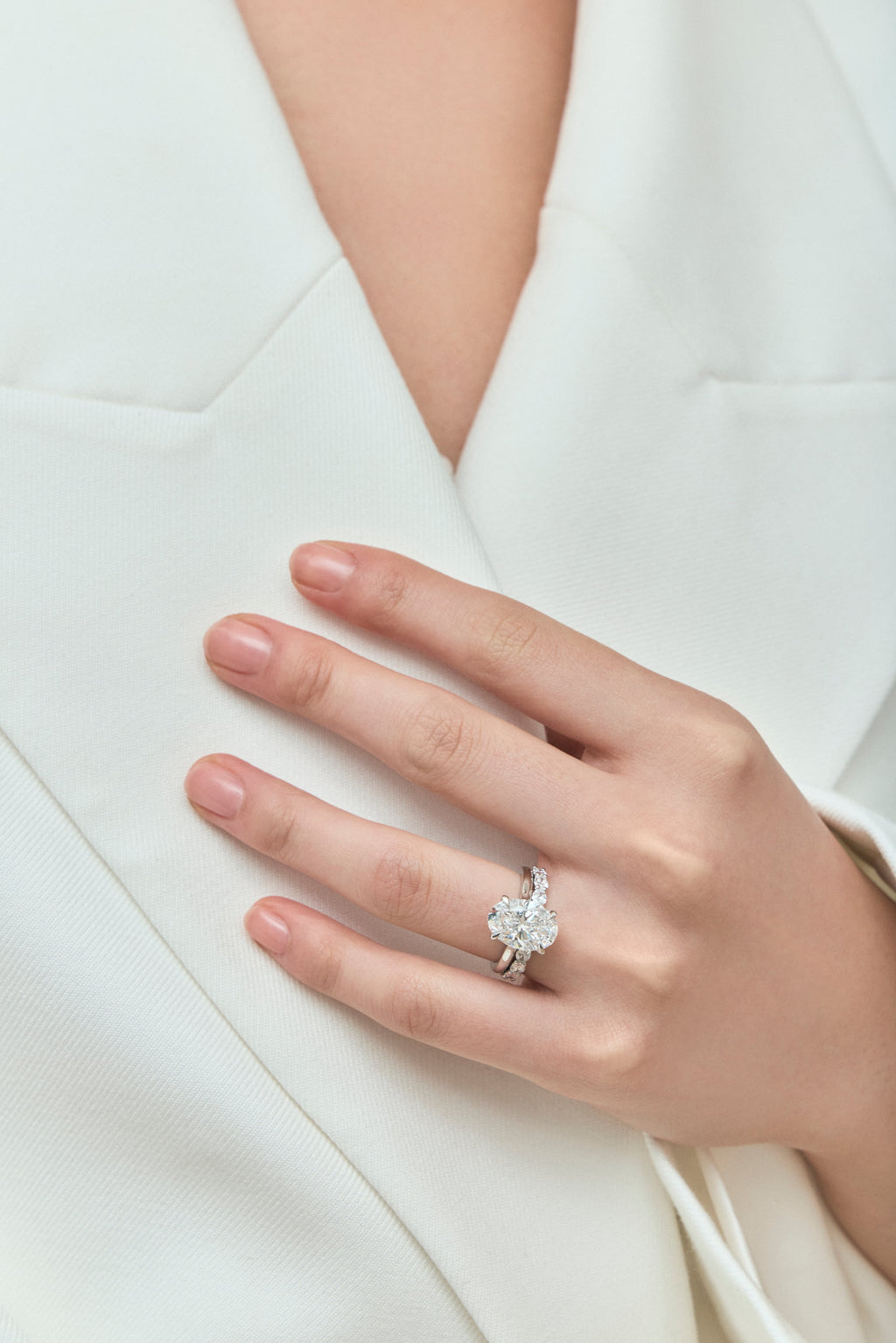 Model wears Hastings 0.10ct oval East-West half set wedding band in 18ct white gold