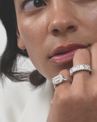 Model wears Soho 0.50ct emerald cut half eternity band in platinum 