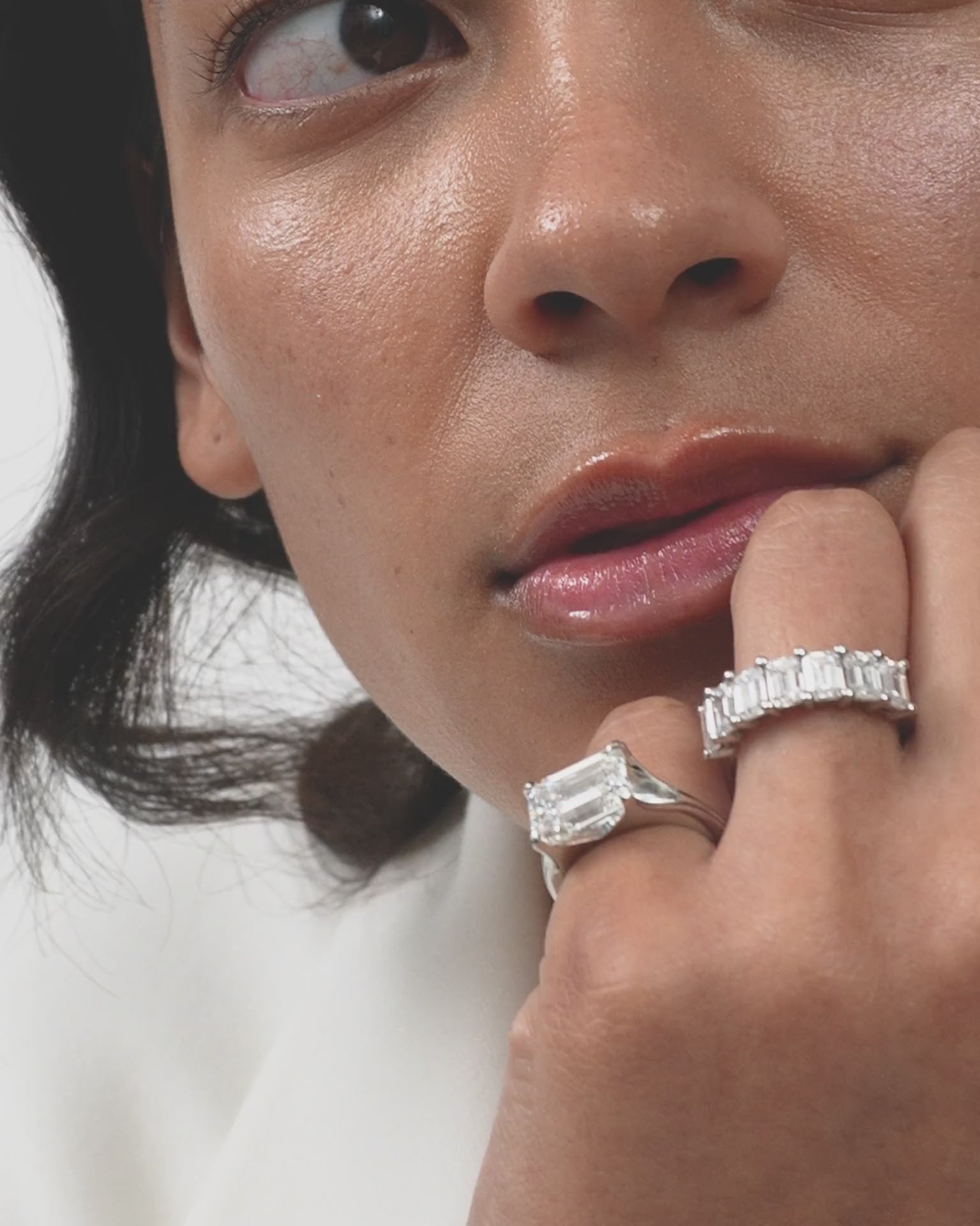 Model wears Soho 0.50ct emerald cut half eternity band in platinum 