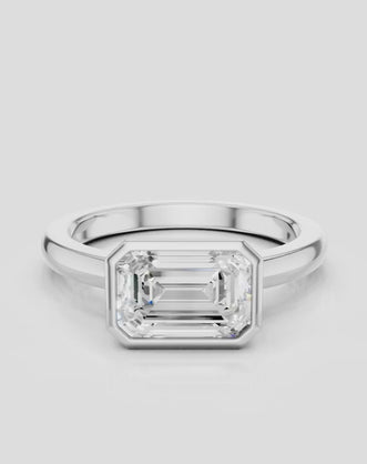 Rowan emerald cut solitaire bezel East-West engagement ring in platinum