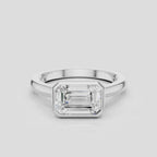 Rowan emerald cut solitaire bezel East-West engagement ring in platinum