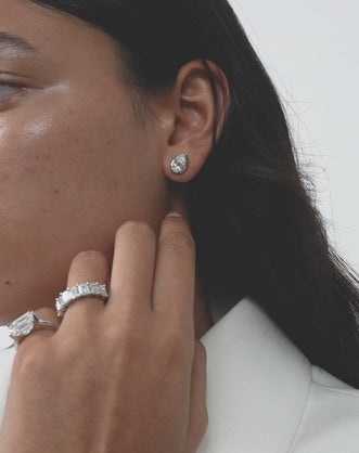 Model wears Moncur 1.5ct pear cut diamond studs in 18ct white gold