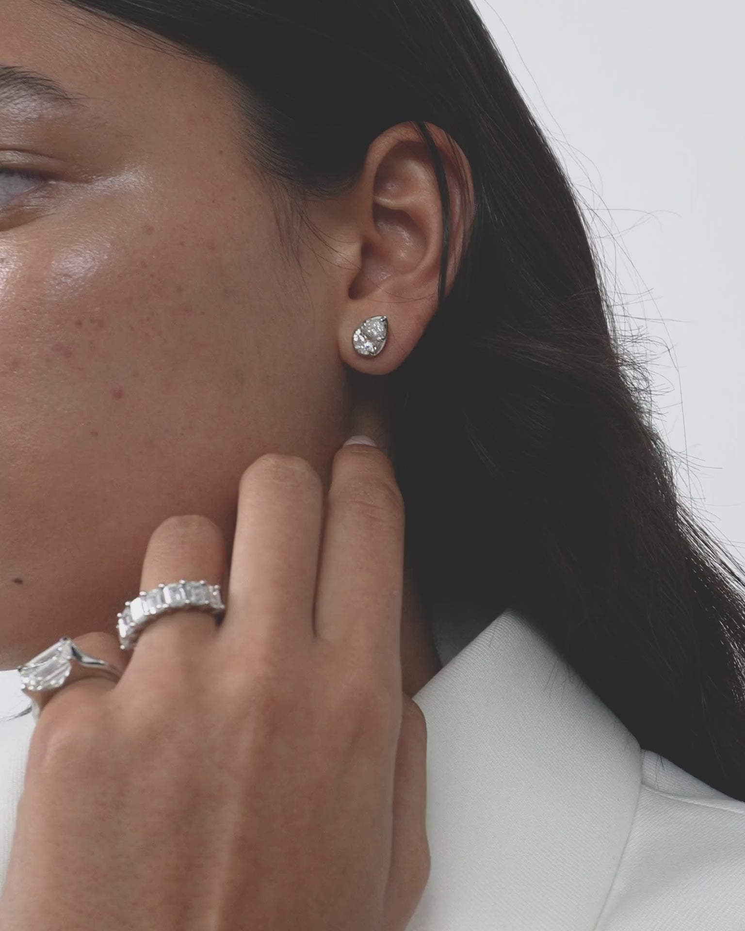 Model wears Moncur 1.5ct pear cut diamond studs in 18ct white gold