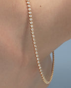Model wearing York bezel set tennis necklace in 18ct yellow gold