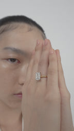 Dover emerald cut solitaire swept shoulder engagement ring with diamond band in 18ct yellow gold