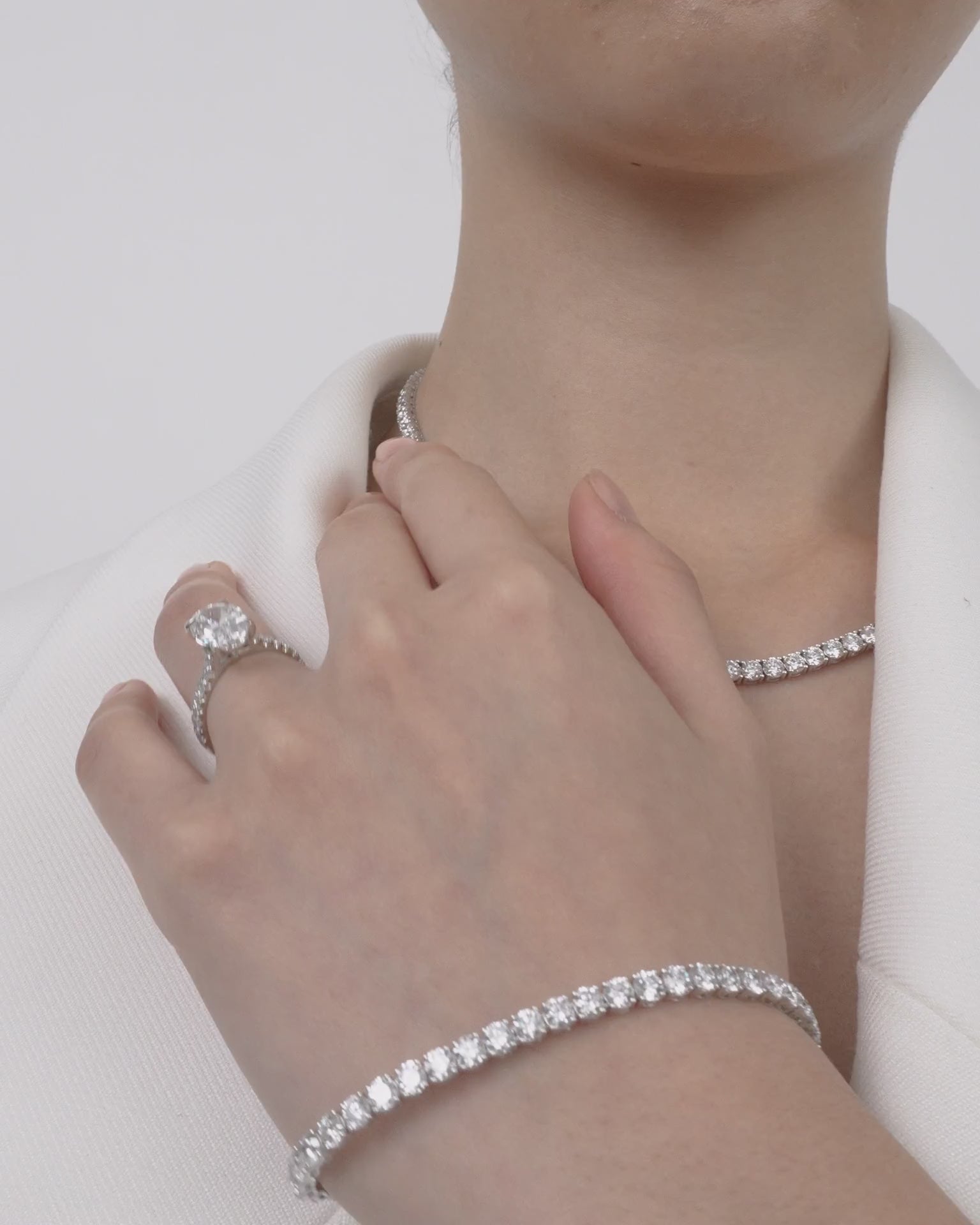 Model wears Nassau oval cut diamond band engagement ring in platinum