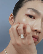 Model wears Vestry 3ct pear solitaire scalloped engagement ring in 18ct yellow gold