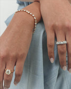 Model wears Chrystie 3ct round brilliant signet bezel grooved band engagement ring in 18ct yellow gold