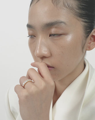 Model wears Soho 0.50ct emerald cut half eternity band in 18ct yellow gold