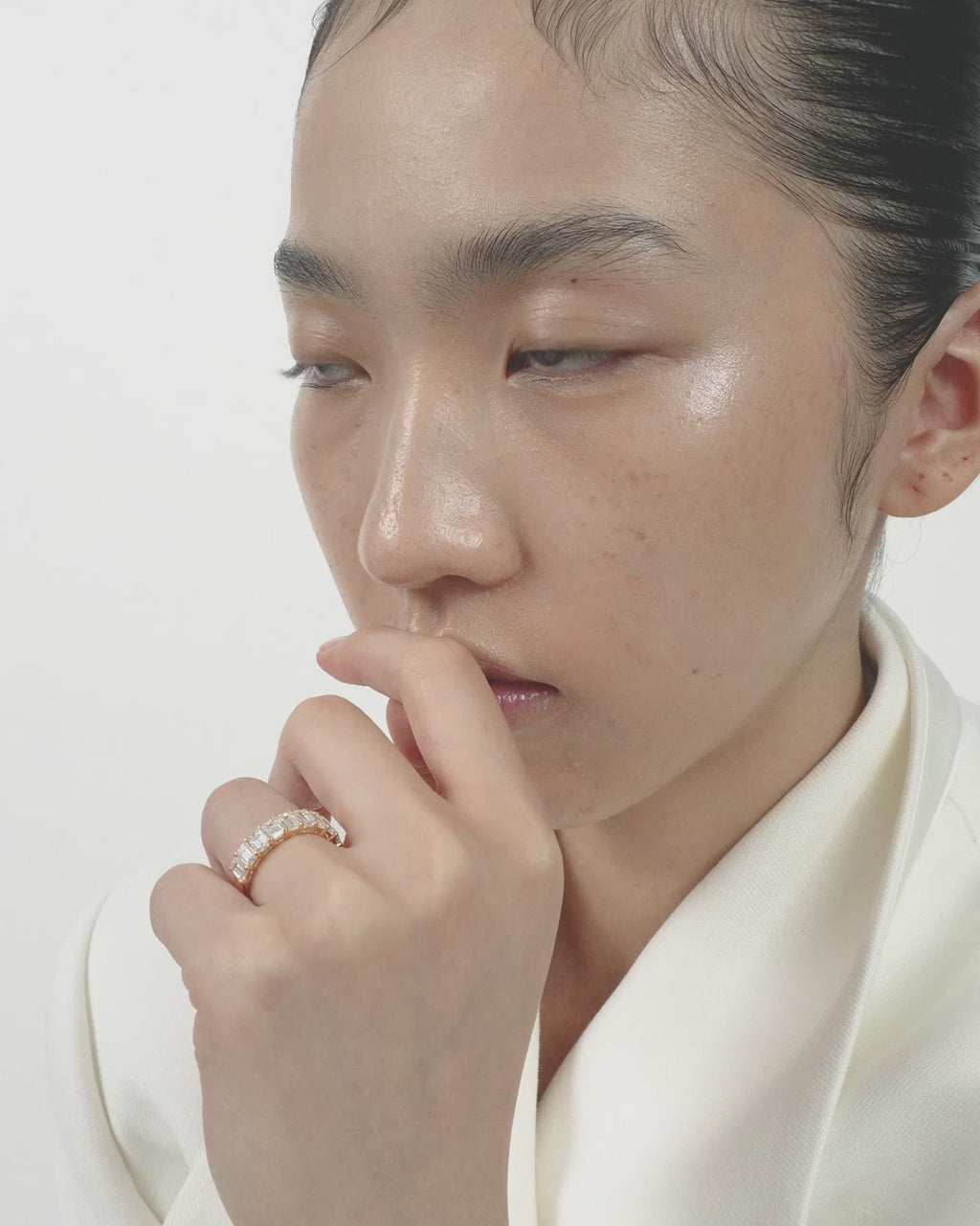 Model wears Soho 0.50ct emerald cut half eternity band in 18ct yellow gold