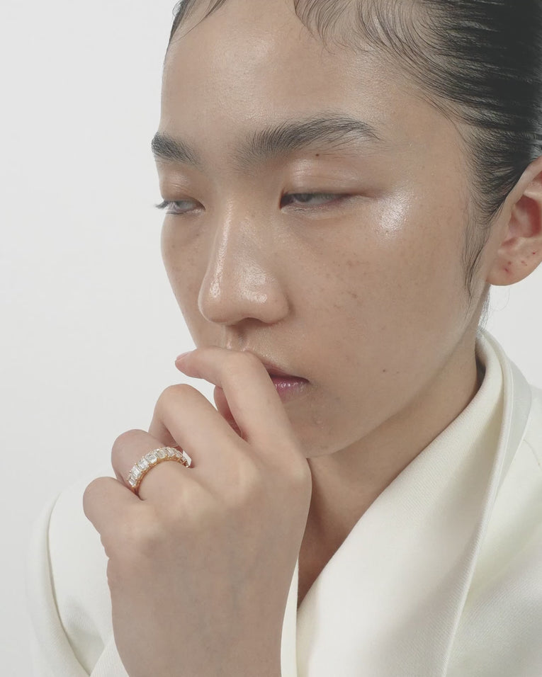 Model wears Soho 0.50ct emerald cut half eternity band in 18ct yellow gold