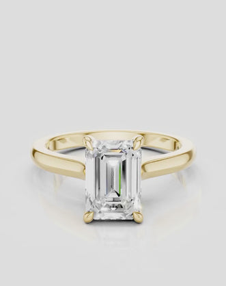 Dover emerald cut solitaire swept shoulder engagement ring in 18ct yellow gold