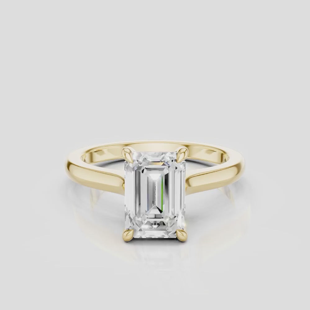 Dover emerald cut solitaire swept shoulder engagement ring in 18ct yellow gold