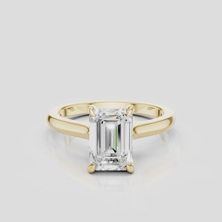 Dover emerald cut solitaire swept shoulder engagement ring in 18ct yellow gold