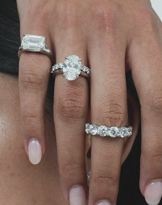 Close-up model wears Cheyne 0.50ct round brilliant half eternity band in 18ct white gold