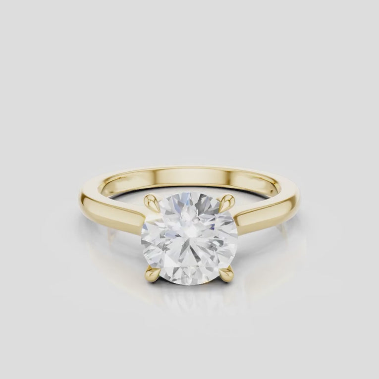 Sloane round brilliant four claw solitaire swept shoulder engagement ring in 18ct yellow gold