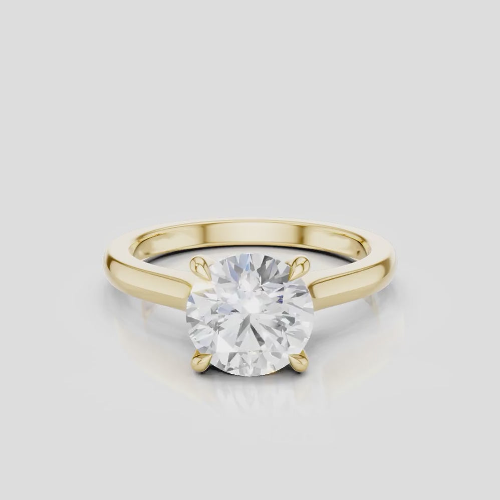 Sloane round brilliant four claw solitaire swept shoulder engagement ring in 18ct yellow gold