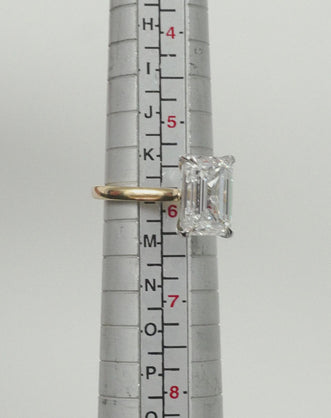 Close-up Soho 0.30ct emerald cut half eternity band in 18ct yellow gold