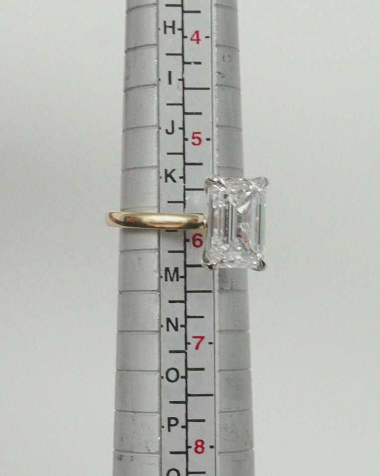 Close-up Soho 0.30ct emerald cut half eternity band in 18ct yellow gold