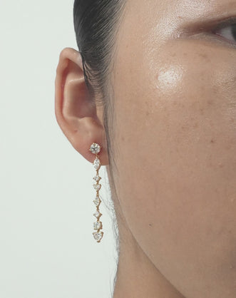 Model wears Noho mixed shape statement drop earrings in 18ct yellow gold 