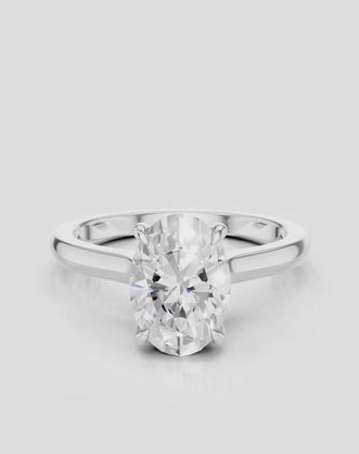 Montaigne oval solitaire swept shoulder engagement ring in platinum