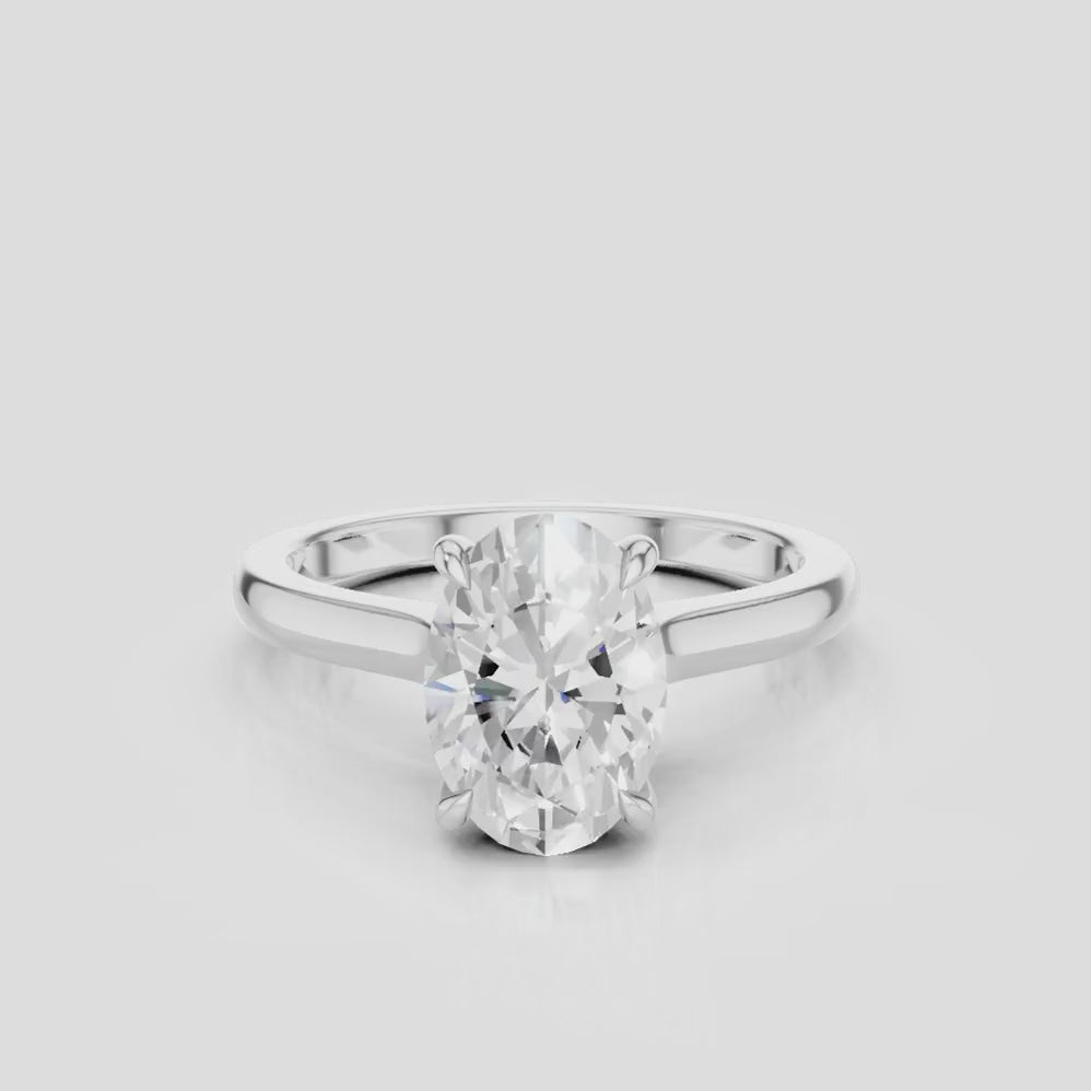 Montaigne oval solitaire swept shoulder engagement ring in platinum