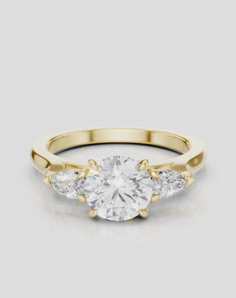 Cornelia round brilliant pear side stone engagement ring with diamond band in 18ct yellow gold