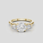Cornelia round brilliant pear side stone engagement ring with diamond band in 18ct yellow gold