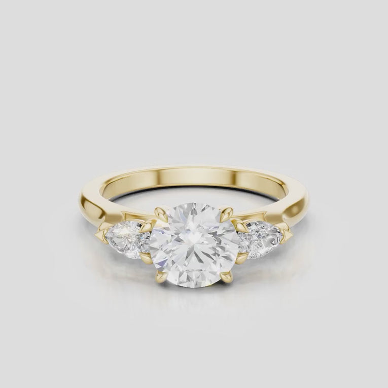 Cornelia round brilliant pear side stone engagement ring with diamond band in 18ct yellow gold