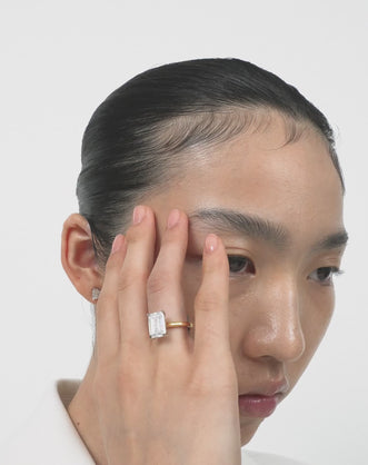 Model wears Lexington emerald cut solitaire classic engagement ring in 18ct yellow gold