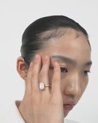 Model wears Lexington emerald cut solitaire classic engagement ring in 18ct yellow gold