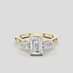 Bruton emerald cut pear side stone engagement ring in 18ct yellow gold