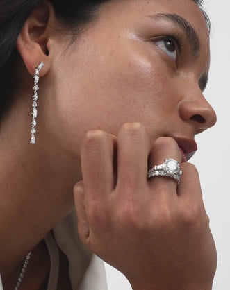 Model wears Hudson 4ct round brilliant tapered baguette engagement ring in 18ct white gold