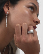 Model wears Hudson 4ct round brilliant tapered baguette engagement ring in 18ct white gold