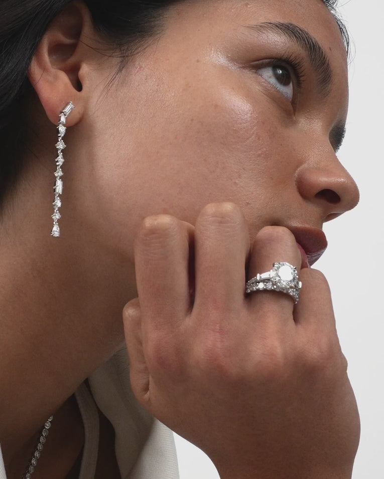 Model wears Hudson 4ct round brilliant tapered baguette engagement ring in 18ct white gold