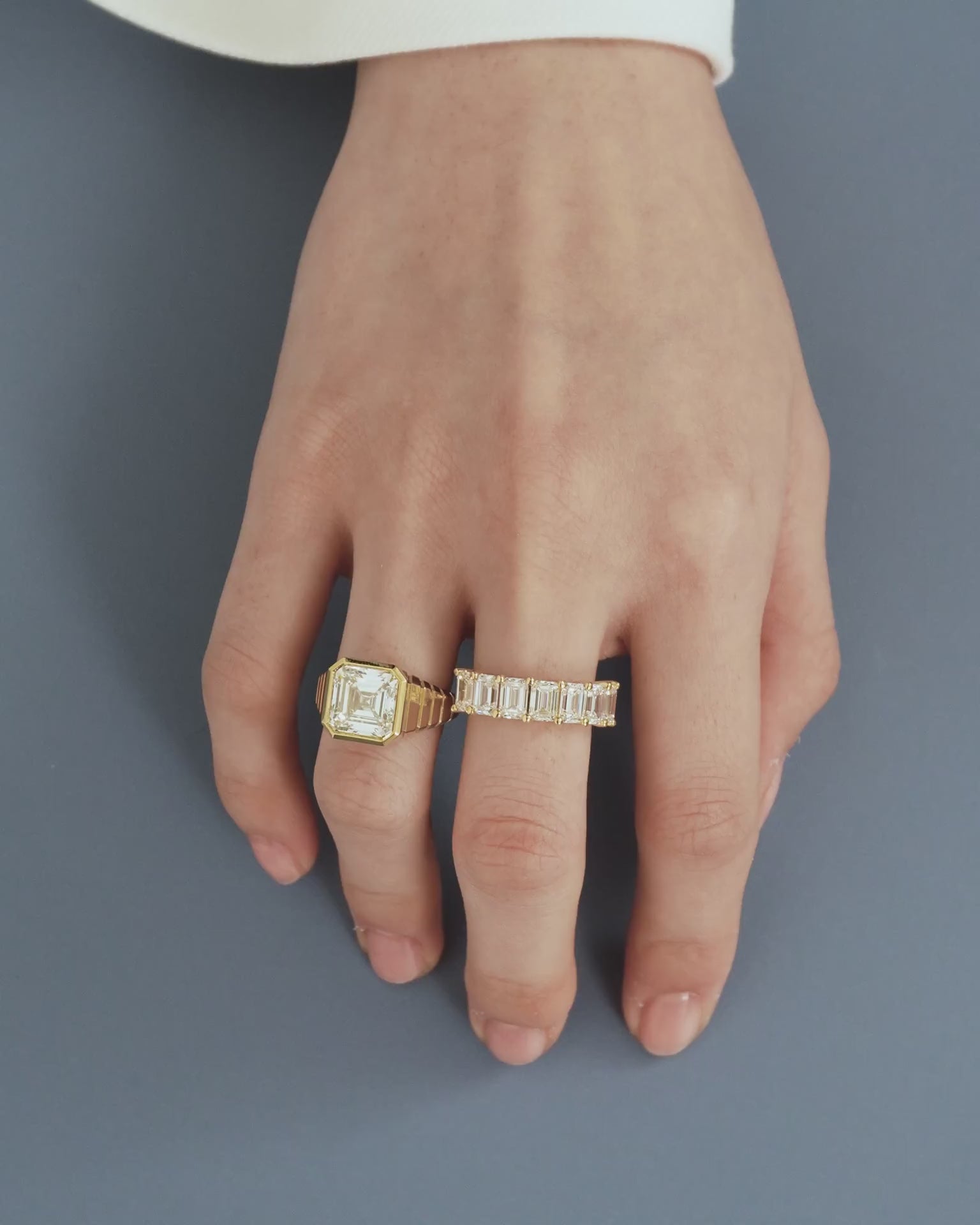 Model wears Soho 0.50ct emerald cut half eternity band in 18ct yellow gold