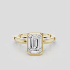 Sutton emerald cut solitaire bezel north-south engagement ring in 18ct yellow gold