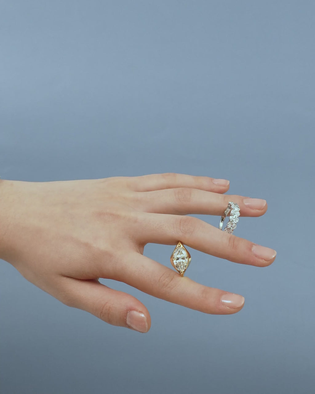 Close-up model wears Cler 0.50ct oval half eternity band in platinum 