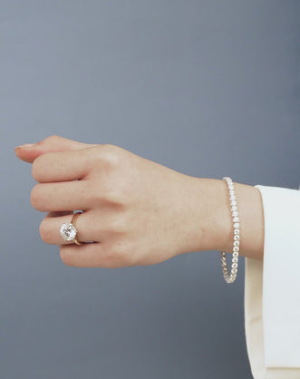 Model wears Cheyne 0.30ct round brilliant half eternity band in 18ct yellow gold