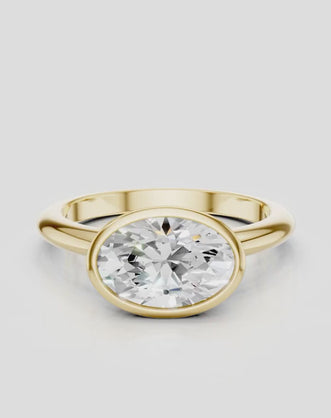 Maddox oval solitaire bezel east-west engagement ring in 18ct yellow gold