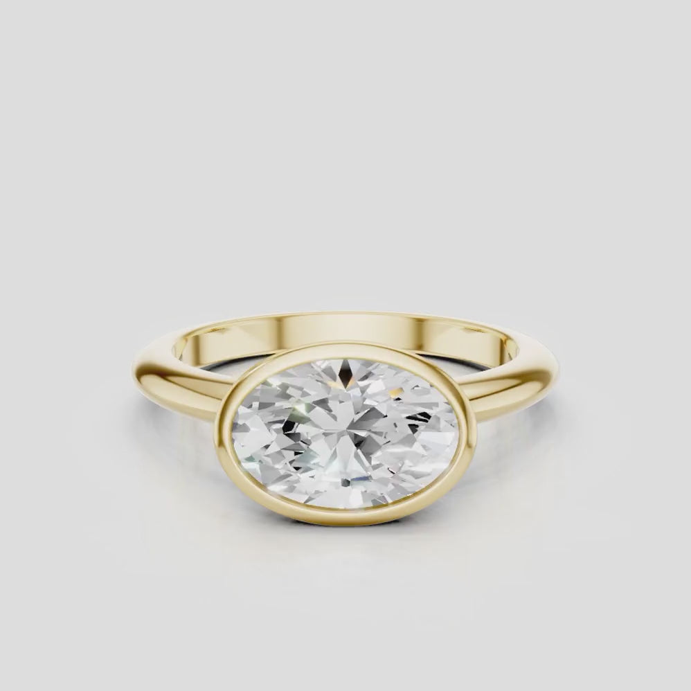 Maddox oval solitaire bezel east-west engagement ring in 18ct yellow gold