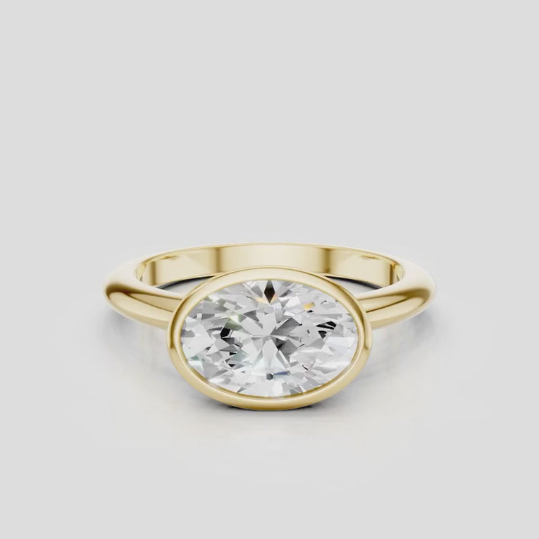 Maddox oval solitaire bezel east-west engagement ring in 18ct yellow gold