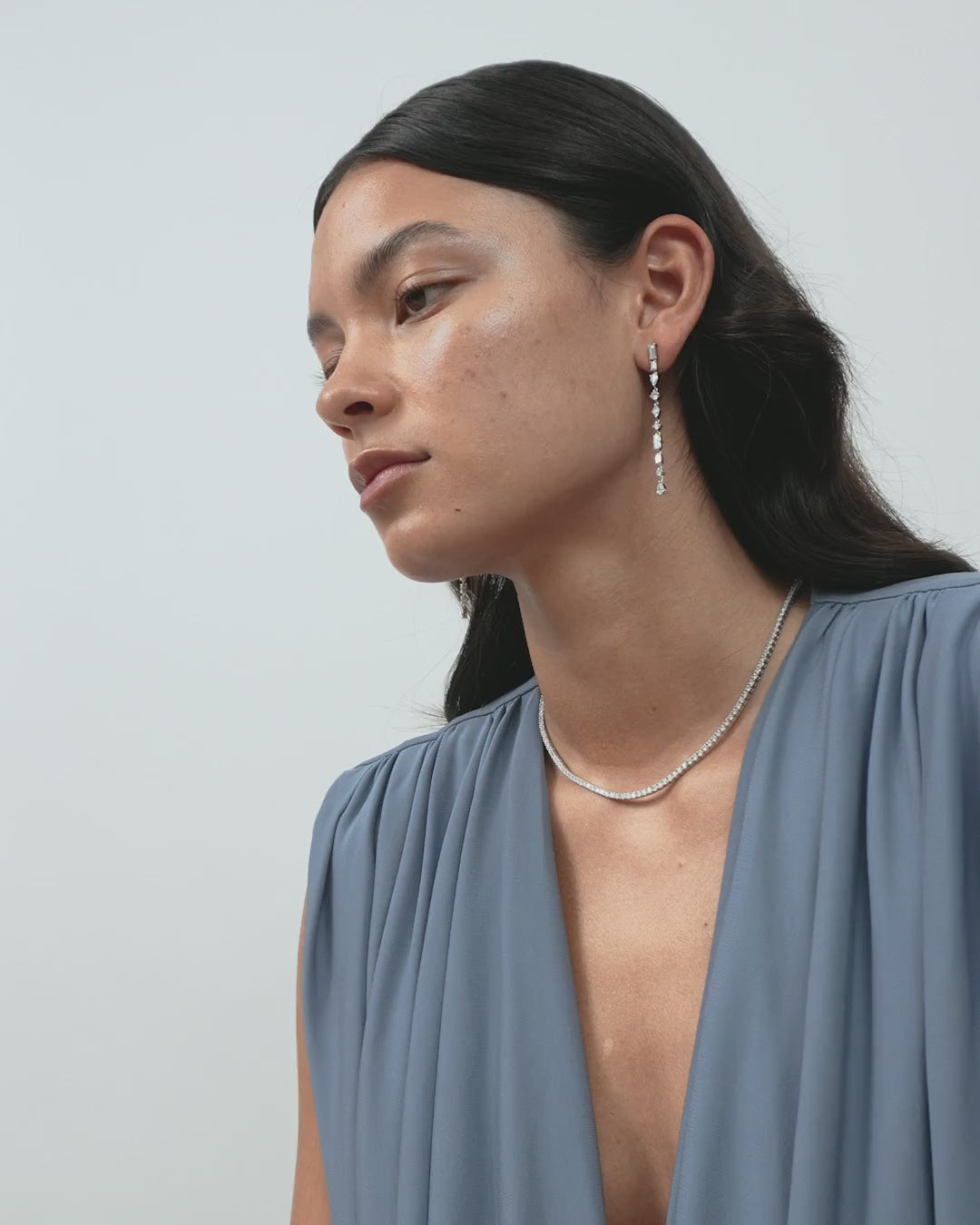 Model wears Tribeca mixed shape statement drop earrings in 18ct white gold
