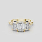 Marion emerald cut trilogy engagement ring in 18ct yellow gold