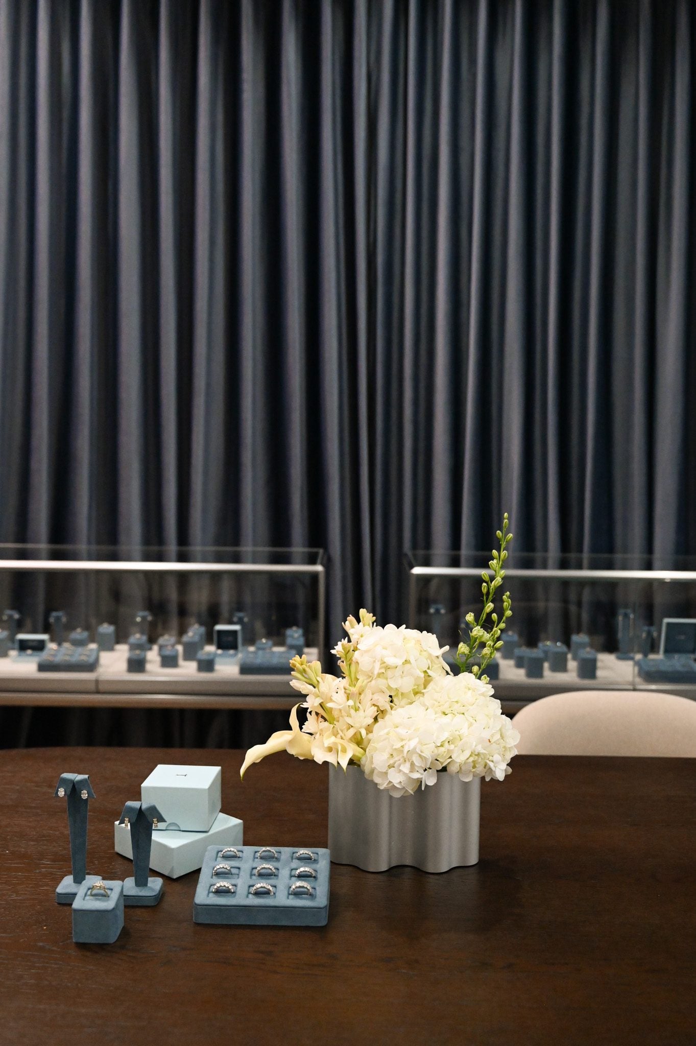 A consultation table at the LOHR showroom set with fresh flowers and velvet ring trays