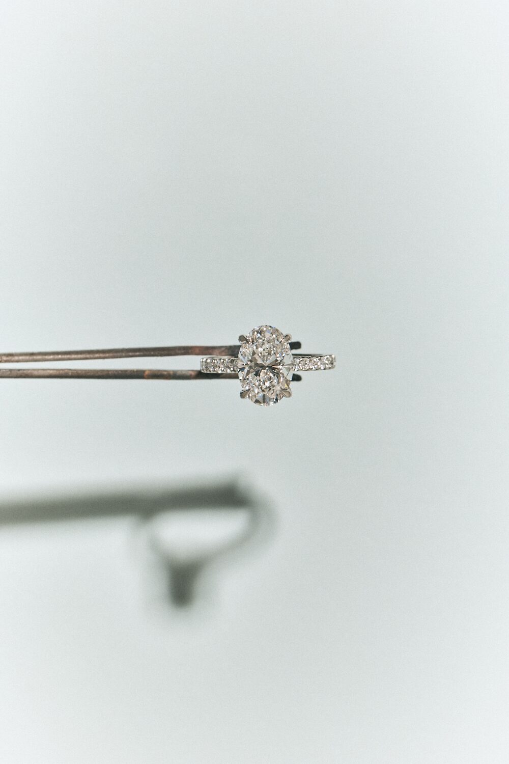 A loose diamond held in jeweller's tweezers